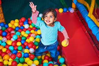 Girl in ball pit at Soft Play City